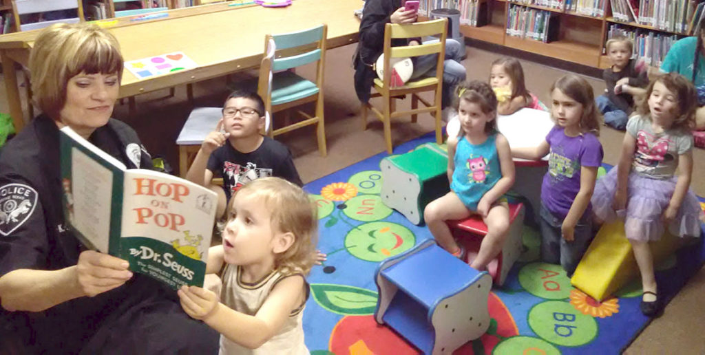 Chief Benavides reading The Devine News